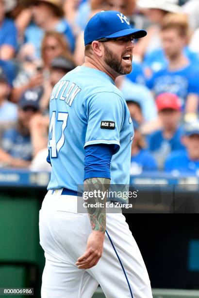 Peter Moylan of the Kansas City Royals directs some words towards plate umpire John Tumpane as he leaves the game in the sixth inning against the...