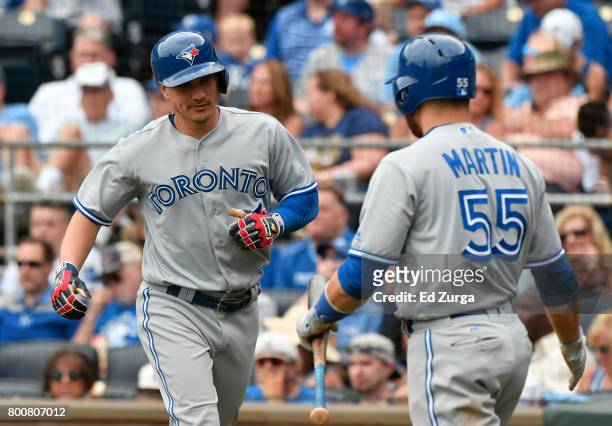 Darwin Barney of the Toronto Blue Jays celebrates with Russell Martin as he scores on a bases loaded walk by Jose Bautista in the sixth inning...