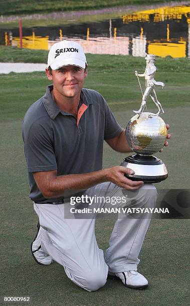 New Zealand golfer Mark Brown poses with his trophy after winning the Johnnie Walker Classic 2008 in Gurgaon on the outskirts of New Delhi on March...