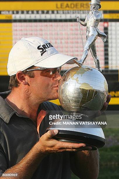 New Zealand golfer Mark Brown kisses his trophy after winning the Johnnie Walker Classic 2008 in Gurgaon on the outskirts of New Delhi on March 2,...