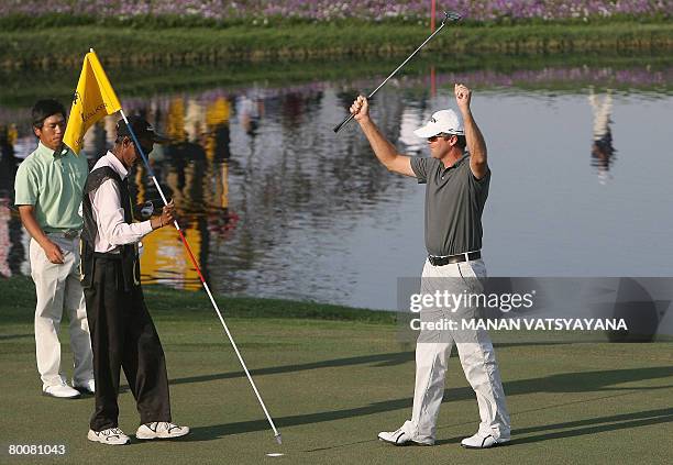 New Zealand golfer Mark Brown celebrates after finishing the eighteenth hole during the Johnnie Walker Classic 2008 in Gurgaon on the outskirts of...