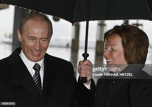 Russian President Vladimir Putin and his wife Lyudmila walk to a polling station in Moscow on March 2, 2008. Russia's voters are expected to endorse...
