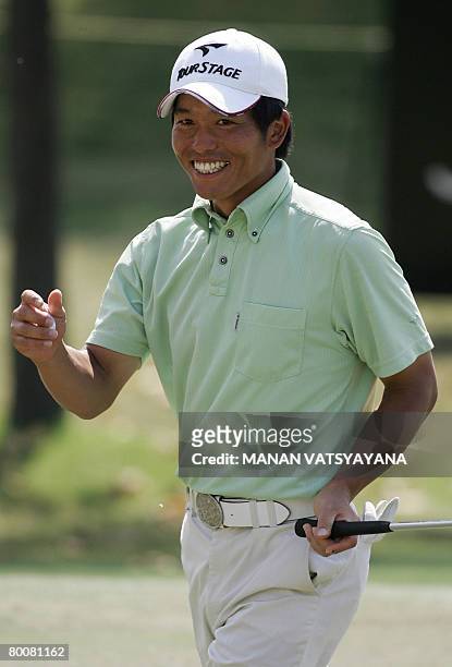 Japanese golfer Taichiro Kiyoto laughs after putting the ball on the seventh hole during the final round of the Johnnie Walker Classic 2008 in...