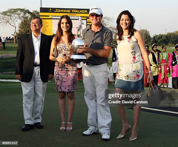 Mark Brown of New Zealand holds the trophy with Mr Asif Adil the MD of Diageo India, Bollywood actress Aarti Chhabria and another Bollywood actress...