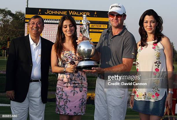 Mark Brown of New Zealand holds the trophy with Mr Asif Adil the MD of Diageo India, Bollywood actress Aarti Chhabria and another Bollywood actress...