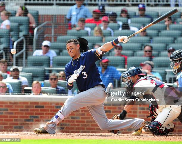 Orlando Arcia of the Milwaukee Brewers is hit in the face by a foul tip during the eighth inning against the Atlanta Braves at SunTrust Park on June...