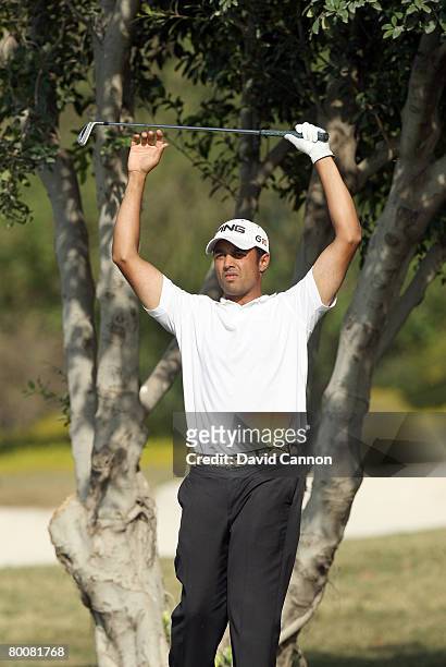 Arjun Atwal of India prepares to hit his second shot to the 18th green during the final round of the 2008 Johnnie Walker Classic held at The DLF Golf...