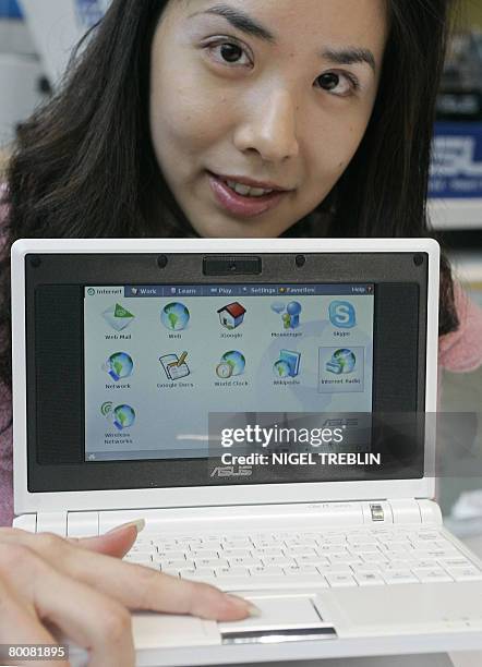 Hostess poses with the labtop "Eee PC" made by Asus at the CEBIT trade fair on March 2, 2008. The world's biggest high-tech fair will be inaugurated...