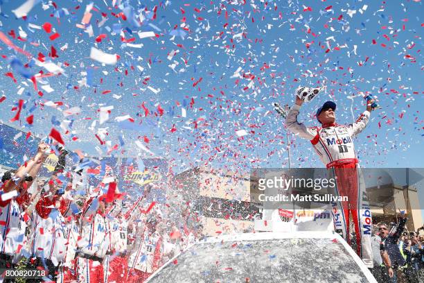 Kevin Harvick, driver of the Mobil 1 Ford, celebrates in victory lane after winning the Monster Energy NASCAR Cup Series Toyota/Save Mart 350 at...