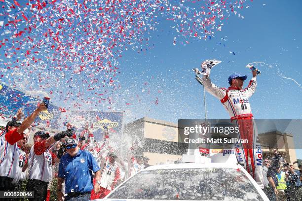 Kevin Harvick, driver of the Mobil 1 Ford, celebrates in victory lane after winning the Monster Energy NASCAR Cup Series Toyota/Save Mart 350 at...