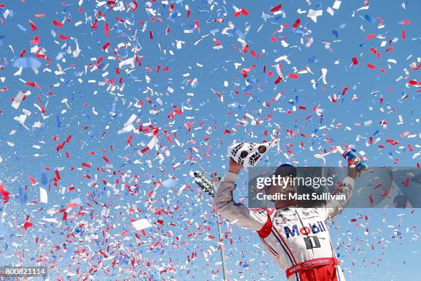 Kevin Harvick, driver of the Mobil 1 Ford, celebrates in victory lane after winning the Monster Energy NASCAR Cup Series Toyota/Save Mart 350 at...