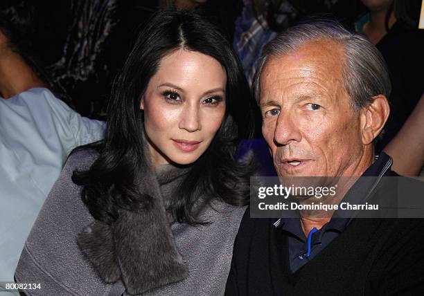 Lucy Liu anf Peter Beard attend the John Galliano fashion show during Paris Fashion Week Fall/Winter 2008 held at the Grande Halle de la Vilette on...