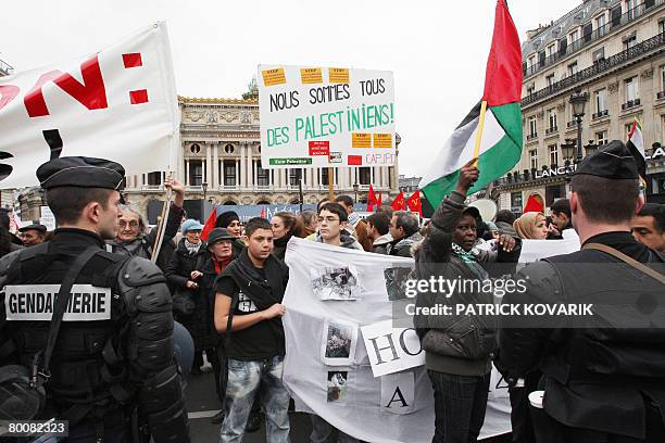 People wave Palestinian flags as they demonstrate against Israel's deadly assault on the Gaza Strip, on March 02, 2008 on the Opera Square in Paris....