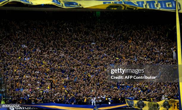 Boca Juniors supporters celebrate after their team defeated Union and won Argentina's first division football championship at La Bombonera stadium in...