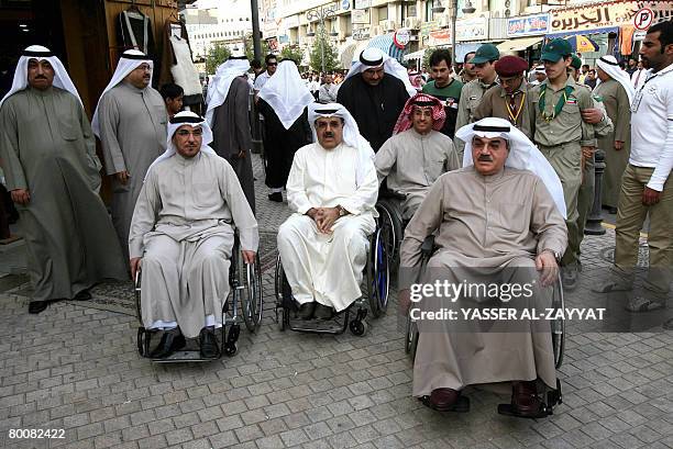 Kuwaiti Public Works and Municipality Minister Mussa al-Sarraf , Health Minister Abdulrahman al-Taweel and MP Hassan Jawhar use wheelchairs in...