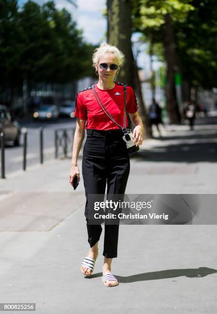 Olga Karput wearing black high waisted pants, red tshirt outside Y-3 during Paris Fashion Week Menswear Spring/Summer 2018 Day Five on June 25, 2017...