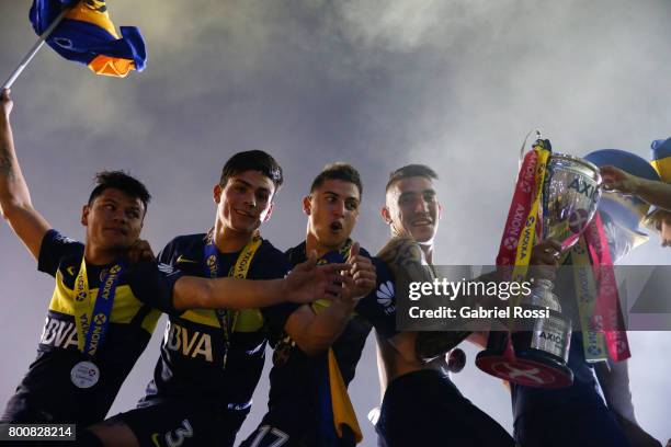 Walter Bou, Jonathan Silva, Nazareno Solis and Ricardo Centurion of Boca Juniors lift the champions trophy to celebrate after a match between Boca...