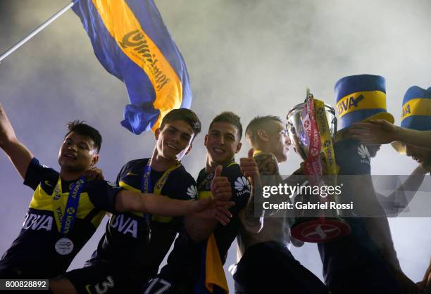 Walter Bou, Jonathan Silva, Nazareno Solis, Ricardo Centurion and Lisandro Magallan of Boca Juniors lift the champions trophy to celebrate after a...