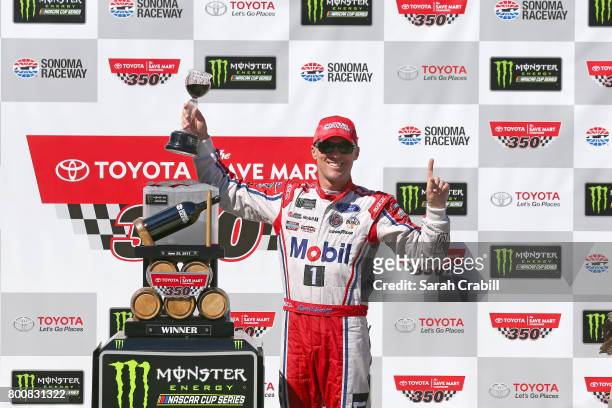 Kevin Harvick, driver of the Mobil 1 Ford, poses with the trophy during the Monster Energy NASCAR Cup Series Toyota/Save Mart 350 at Sonoma Raceway...