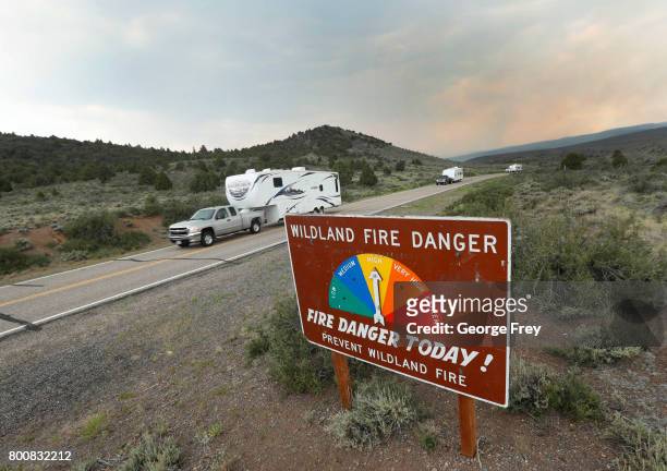 People remove travel trailers down highway 143 from their homes that have been evacuated due to a wildfire on June 25, 2017 outside Panguitch, Utah....