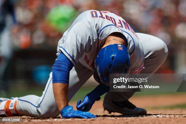 Michael Conforto of the New York Mets reacts after getting hit by a pitch during the fifth inning against the San Francisco Giants at AT&T Park on...