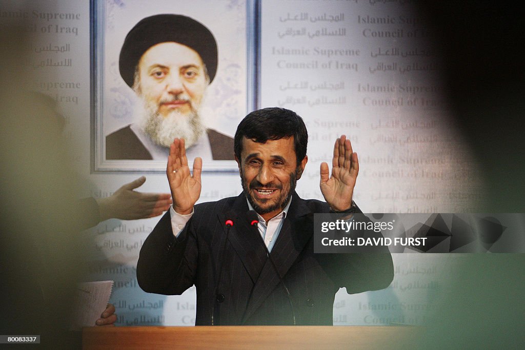 Standing beneath a picture of Mohammed B
