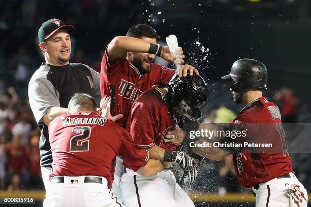 Daniel Descalso of the Arizona Diamondbacks is congratulated by teamamtes after hitting the game winning RBI single against the Philadelphia Phillies...