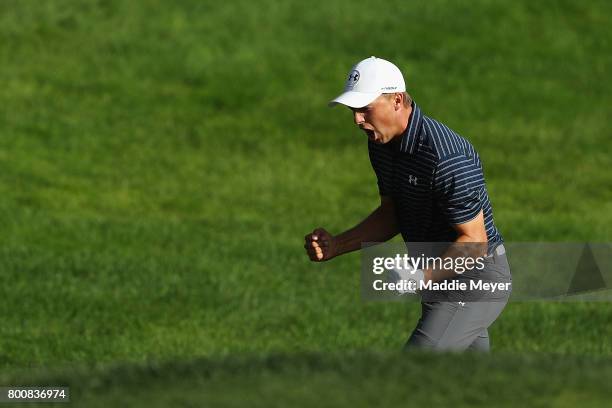 Jordan Spieth of the United States celebrates after chipping in for birdie from a bunker on the 18th green to win the Travelers Championship in a...