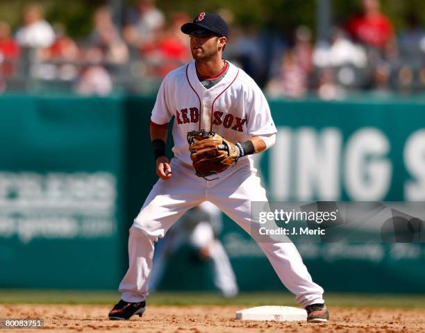 Infielder Dustin Pedroia of the Boston Red Sox prepares for the throw from the outfield during the game against the Minnesota Twins on March 2, 2008...