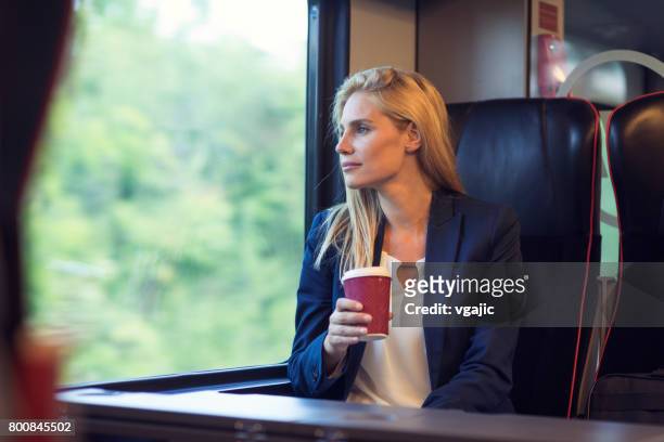 businesswoman in the train - commuter train stock pictures, royalty-free photos & images