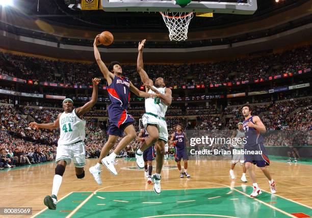 Josh Childress of the Atlanta Hawks dunks the ball against Leon Powe of the Boston Celtics on March 2, 2008 at the TD Banknorth Garden in Boston,...