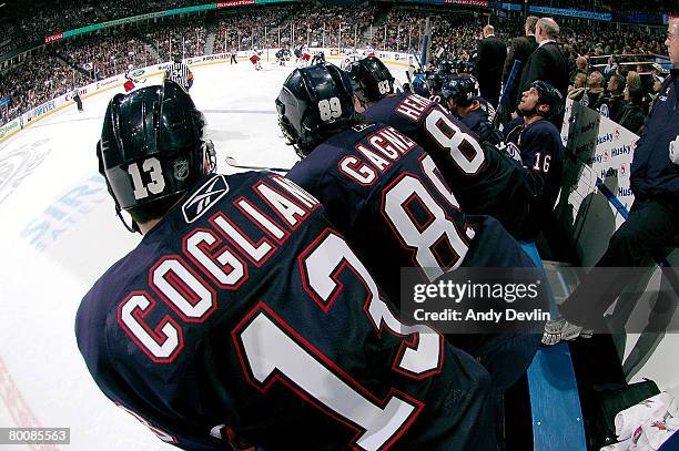 Andrew Cogliano, Sam Gagner and Ales Hemsky of the Edmonton Oilers lean over the boards to watch the play against the Columbus Blue Jackets at Rexall...