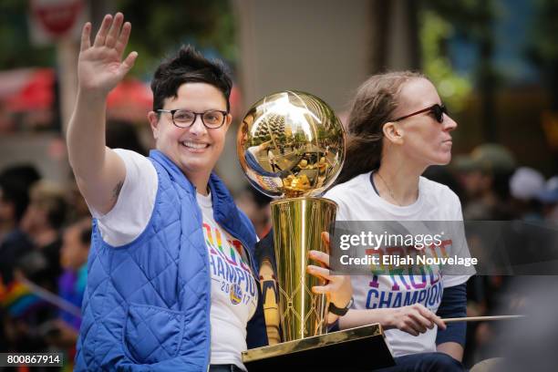 Woman holds the NBA's Larry O'Brien Championship Trophy while riding in a car in the annual LGBTQI Pride Parade on Sunday, June 25, 2017 in San...