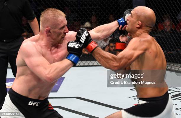 Dennis Siver of Germany punches BJ Penn in their featherweight bout during the UFC Fight Night event at the Chesapeake Energy Arena on June 25, 2017...