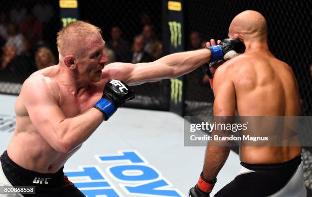 Dennis Siver of Germany punches BJ Penn in their featherweight bout during the UFC Fight Night event at the Chesapeake Energy Arena on June 25, 2017...