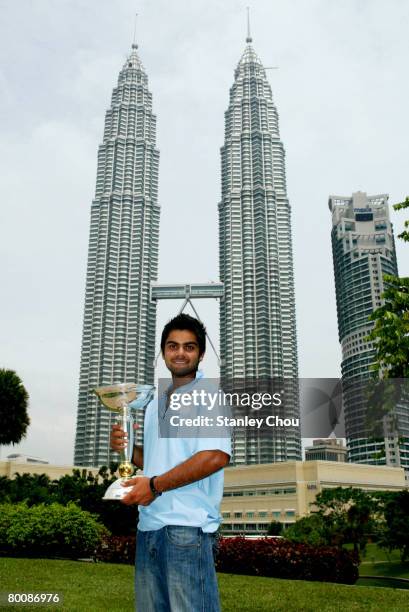 Virat Kohli of India poses with the ICC U19 Cricket World Cup at the Kuala Lumpur Twin Towers on March 3, 2008 in Kuala Lumpur, Malaysia.