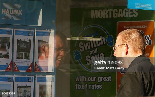Man stops to look in the window of a branch of Halifax estate agents on March 3, 2008 in Bath, United Kingdom. Banks and building societies in the UK...