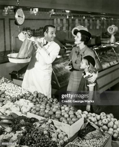 mother and daughter in supermarket, shop assistant weighing groceries - old fashioned general store stock pictures, royalty-free photos & images