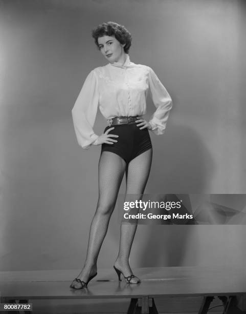 woman with hands on hips, portrait - short shorts stock pictures, royalty-free photos & images