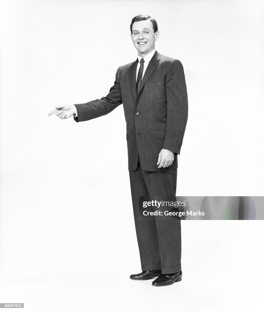 Man in full suit gesturing, portrait