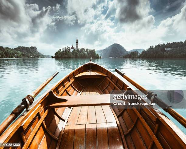 sailing on the bled lake in slovenia - wooden boat stock pictures, royalty-free photos & images