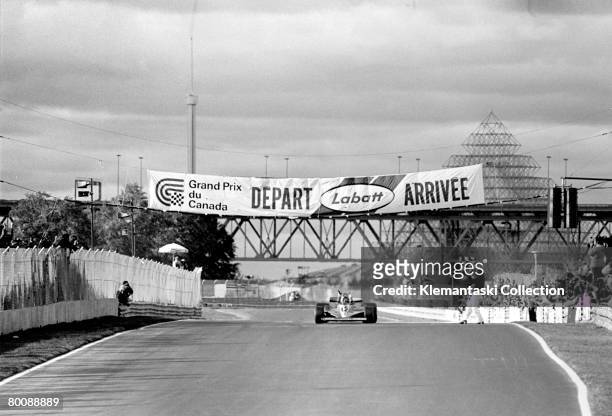 Gilles Villeneuve takes the checkered flag in his Ferrari 312T3 at the end of the Canadian Grand Prix, Ile Notre-Dame , 8th October 1978. It was the...