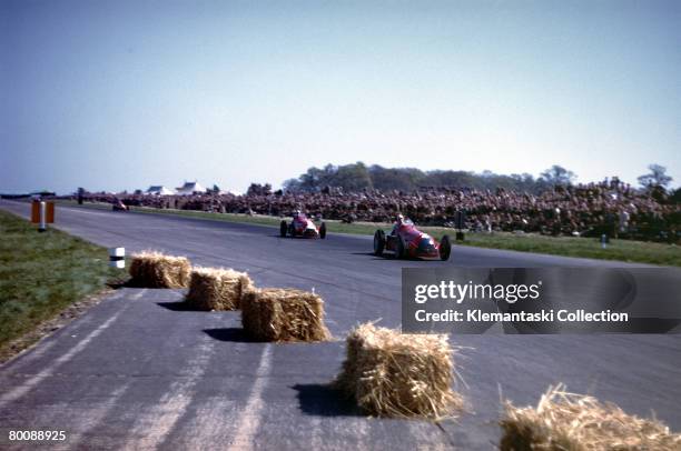 The Alfa Romeo 159 of Giuseppe Farina leading the sister car driven by Luigi Fagioli during the British Grand Prix at Silverstone, 13th May 1950.