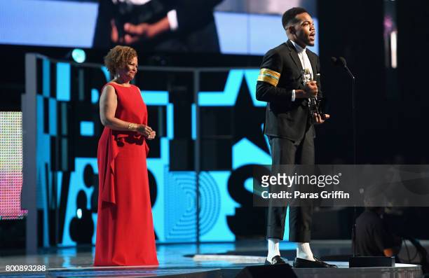 Chance The Rapper accepts the Humanitarian Award from Chairman and Chief Executive Officer of BET Debra L. Lee onstage at 2017 BET Awards at...