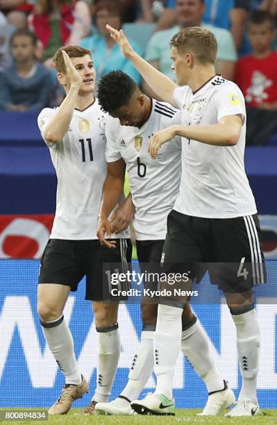 Timo Werner celebrates with Benjamin Henrichs and Matthias Ginter after scoring Germany's third goal in the second half of a Group B match against...