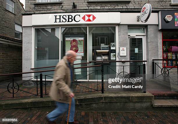 Man walks past a branch of HSBC on March 3, 2008 in Street, United Kingdom. HSBC, the UK's largest bank, has said it has made a 8.7bn GBP loss, after...