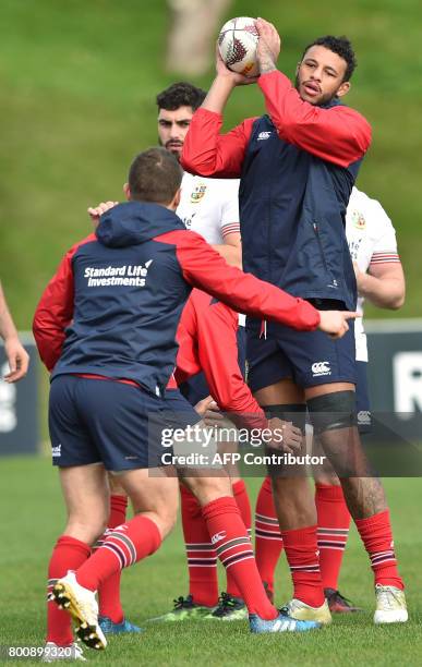 British and Irish Lions' Courtney Lawes catches the ball with his teammates during their Captains Run ahead of their rugby game against the...