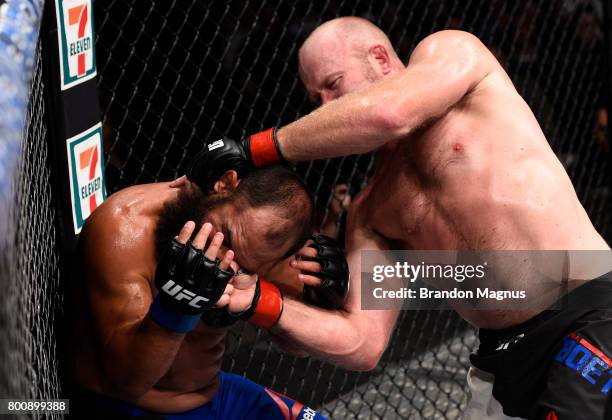 Tim Boetsch punches Johny Hendricks in their middleweight bout during the UFC Fight Night event at the Chesapeake Energy Arena on June 25, 2017 in...