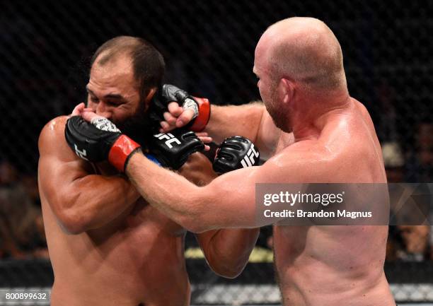 Tim Boetsch punches Johny Hendricks in their middleweight bout during the UFC Fight Night event at the Chesapeake Energy Arena on June 25, 2017 in...