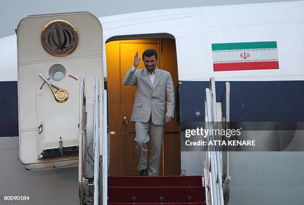 Iranian President Mahmoud Ahmadinejad waves as he disembarks from his plane, which touched down in Tehran on March 3, 2008 after an historic two-day...
